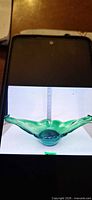 Top view of green hand blown freeform bowl showing wings and base