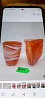 Front view of both orange and white swirl glass pieces