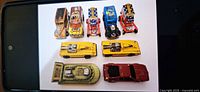 Group of nine vintage Hot Wheels cars laid out on white background