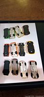Twelve Hot Wheels cars underside view showing bases and wheel condition