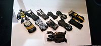 Group shot of eleven Batmobile cars and Batman figure
