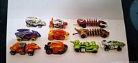 Top-down view of all ten Hot Wheels cars arranged in two rows