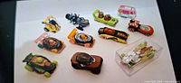 Group shot of all 11 Hot Wheels cars including one in display case