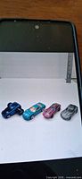 Four Hot Wheels Corvette cars on white background
