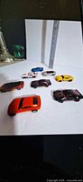 Eight Camaro die-cast cars laid out, various colors visible