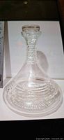 Full view of clear glass decanter with stopper illustrating body pattern and condition