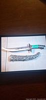 Dagger with scabbard displayed together