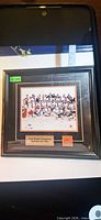 Front view showing framed Team Canada Gold Medal Champions print with plaque and logo
