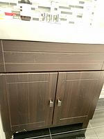 Front view of espresso vanity cabinet with doors and drawer fronts