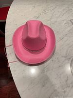 Full view of pink cowboy hat on countertop
