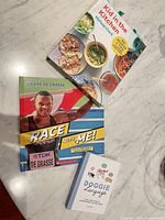 All three hardcover books spread on countertop