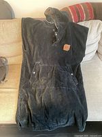 Full view of charcoal hooded changing robe on couch