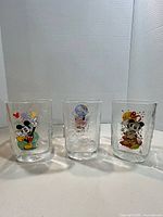 Three tumblers angled to show embossed 2000 pattern and partial graphics