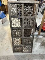 full view of wood and metal window cover standing upright