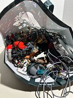 Bag filled with mixed Skylanders and Disney Infinity figures and cables