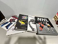 Group shot of five hardcover books partially overlapping