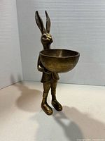 Front view of brass rabbit holding bowl