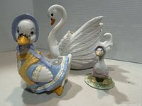Lot overview showing swan vase, larger Jemima Puddleduck vase, and small Jemima figurine