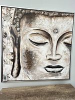 Full view of framed Buddha face painting