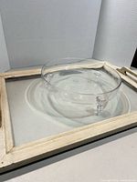 glass dish on top of wooden serving tray