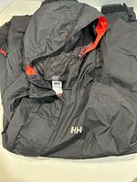 Folded jacket showing hood, mesh lining, HH logo