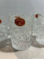 Close-up of one glass showing Bohemia sticker and cut pattern