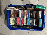 Overview of blue tote filled with VHS tapes showing quantity and several identifiable titles