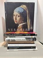 Stack of nine coffee table books with Vermeer cover facing front