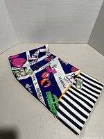 Folded scarf showing striped border and motif