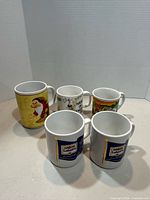 Five mugs grouped to show fronts