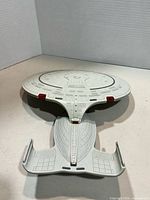 Top view of grey plastic starship toy showing saucer and rear hull