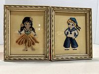 Front view showing both framed needlepoint pictures and motifs