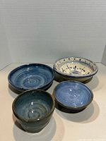 Four glazed pottery bowls grouped together