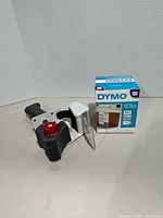 DYMO labels box beside gray tape dispenser