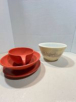Group overview of Pyrex bowl with three red melamine pieces
