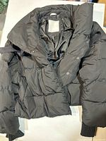 Front view showing collar, snap front, quilting and lining