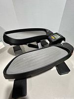 Overall view of compact stepping machine showing both foot pedals and LCD counter