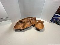 Leaf-shaped multi-compartment tray and pineapple bowl displayed together
