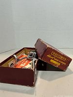 Clipper inside open Craftsman box, lid shows label