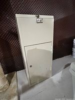 Front view of beige metal cabinet standing upright