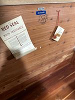 Detail of interior lid with Eaton’s label, quality stamp and Red Seal pamphlet