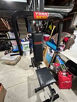 Front view showing seat, backrest, chest press/fly arms and branding