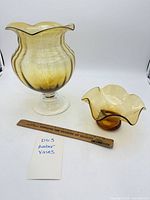 Both amber glass vases with ruler for scale