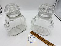 Both apothecary jars with ruler for scale