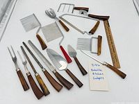 All utensils laid out showing Bakelite handles and metal ends