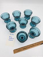 Top view of all eight blue dessert dishes arranged in group