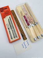 Both carving sets side by side showing all pieces and packaging