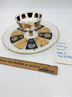 Full view of glass chip and dip platter with attached dip bowl showing coin motif