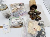 Overview of all containers: jar, tube and zipper bags of buttons