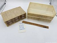 Both plastic storage organizers side by side with ruler for scale